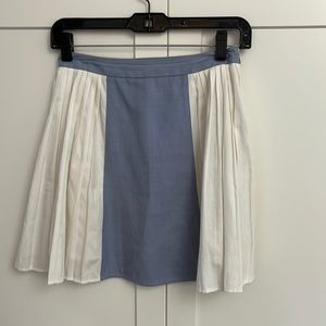 Mini skirt with chambray and cream and pleated sides.